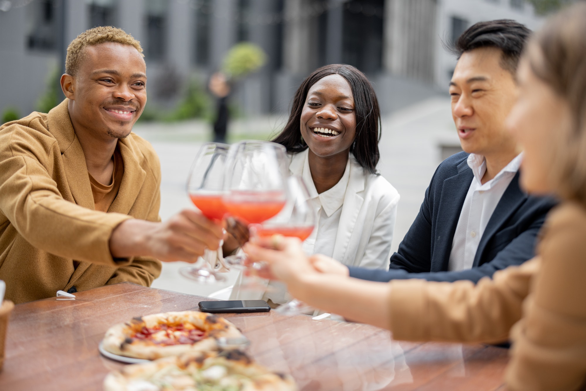 Group of business team celebrating at outdoor cafe